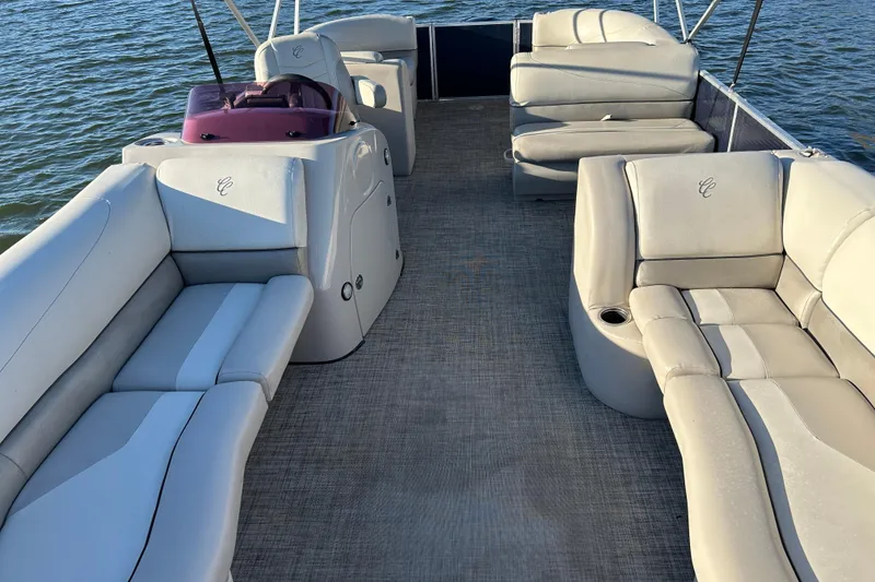 Slide: The Image of 2022 Cypress Cay Seabreeze 232 pontoon boat interior with spacious seating on water. - 8