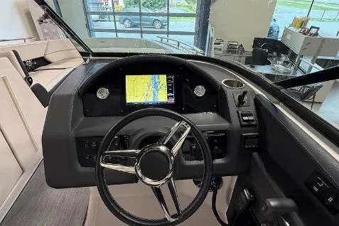 Slide: The Image of 2020 Regal 2800 Bowrider dashboard with steering wheel and navigation display. - 11