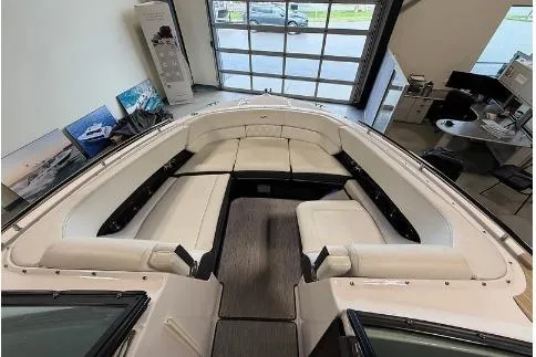 Slide: The Image of 2020 Regal 2800 Bowrider interior with spacious seating in a showroom setting. - 14