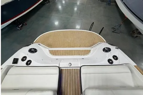 Slide: The Image of 2020 Regal 2800 Bowrider boat interior with teak flooring and white seating. - 5