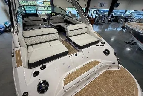 Slide: The Image of 2020 Regal 2800 Bowrider boat with luxurious seating and sleek design in showroom. - 6