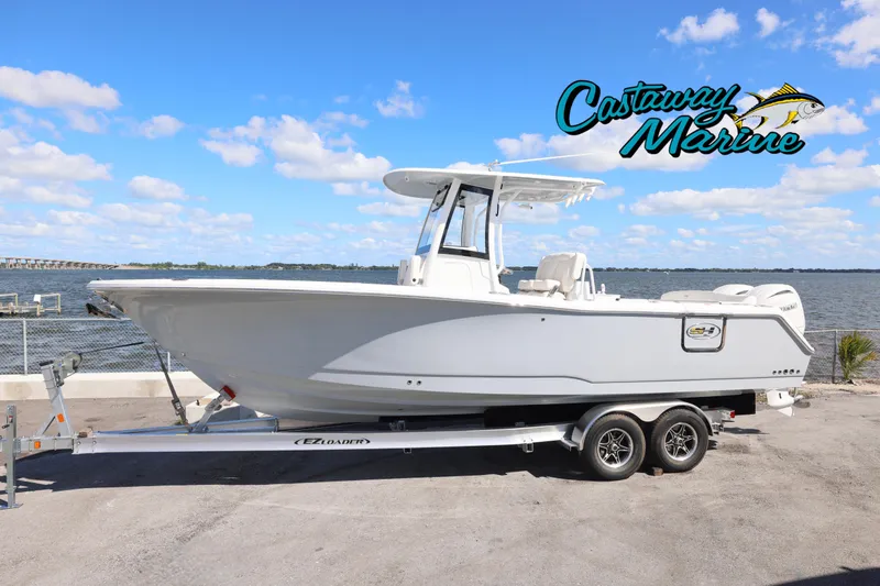 Slide: The Image of 2026 Sea Hunt Ultra 275 Coffin Box boat on trailer by waterfront. - 0