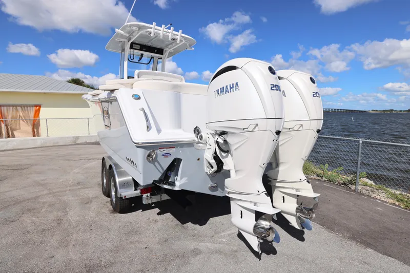 Slide: The Image of 2026 Sea Hunt Ultra 275 Coffin Box boat with twin Yamaha engines by the water. - 11