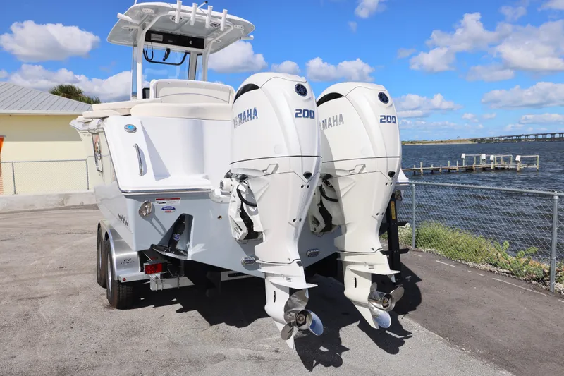 Slide: The Image of 2026 Sea Hunt Ultra 275 Coffin Box with twin Yamaha 200 engines by the water. - 12