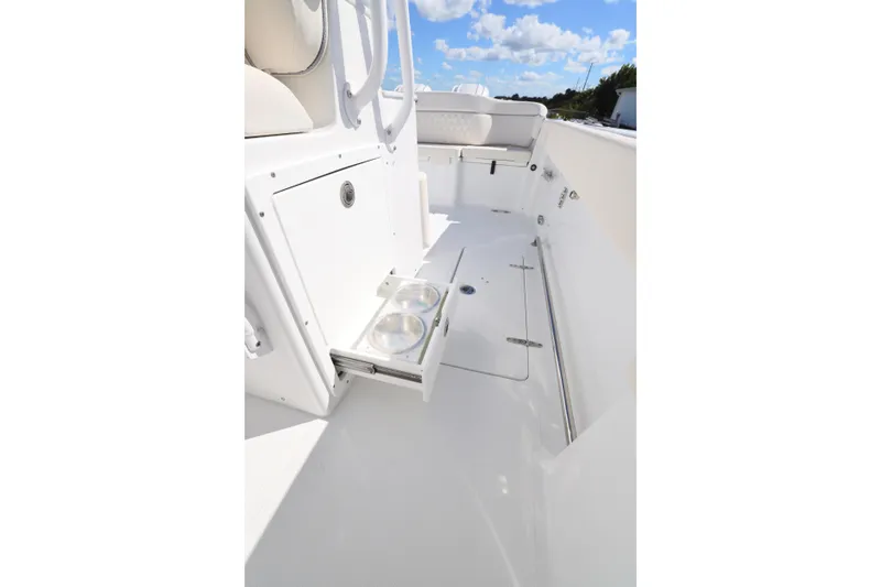 Slide: The Image of 2026 Sea Hunt Ultra 275 Coffin Box interior with storage and cup holders. - 14