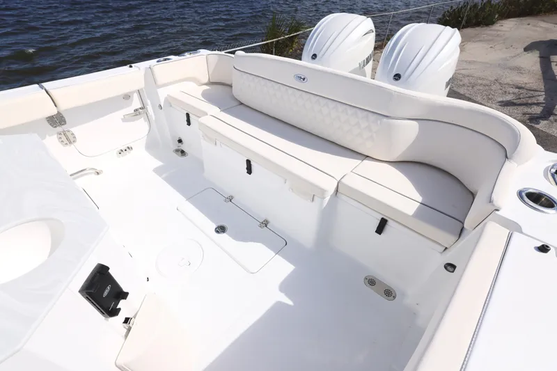 Slide: The Image of 2026 Sea Hunt Ultra 275 Coffin Box boat interior with cushioned seating and dual engines. - 5