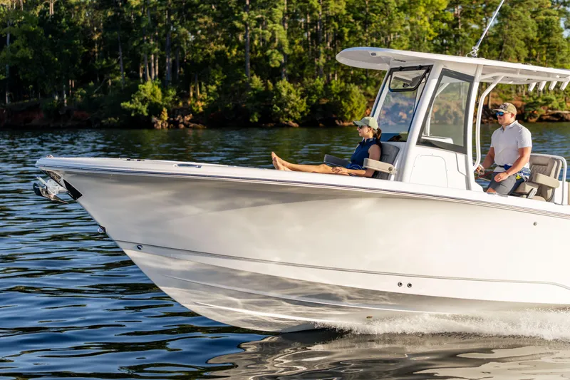 Slide: The Image of 2026 Sea Hunt Ultra 275 Coffin Box boat cruising on a serene lake. - 58