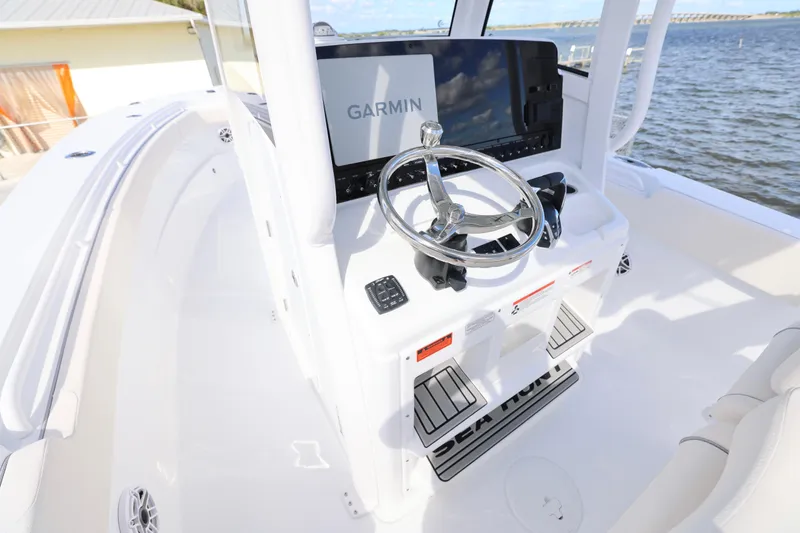 Slide: The Image of 2026 Sea Hunt Ultra 275 Coffin Box boat helm with Garmin display and steering wheel. - 6