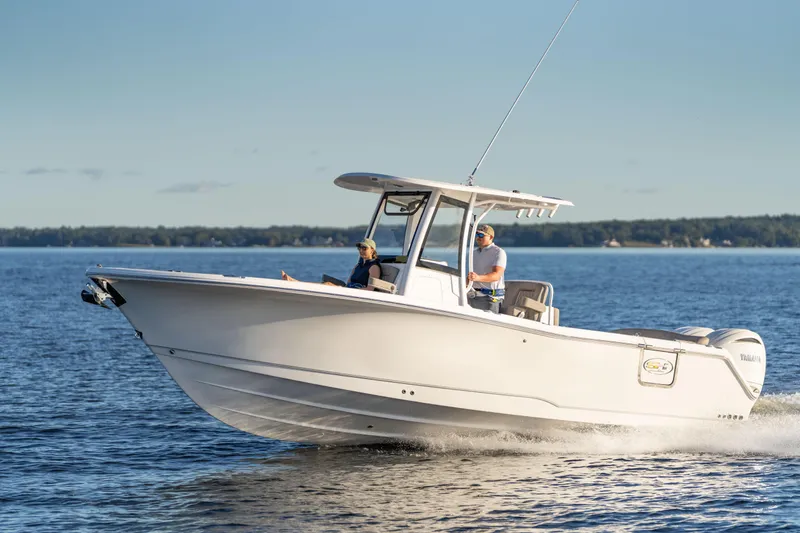 Slide: The Image of 2026 Sea Hunt Ultra 275 Coffin Box boat on water, clear sky background. - 62