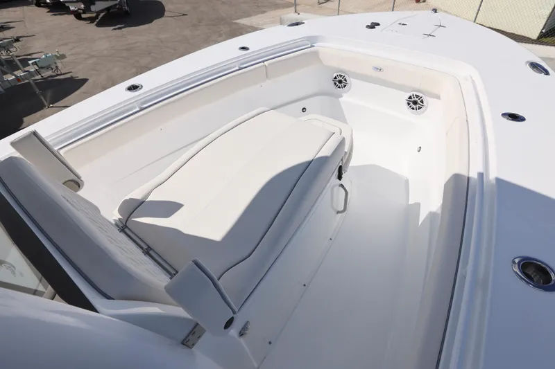 Slide: The Image of 2026 Sea Hunt Ultra 275 Coffin Box boat interior with seating and speakers. - 9