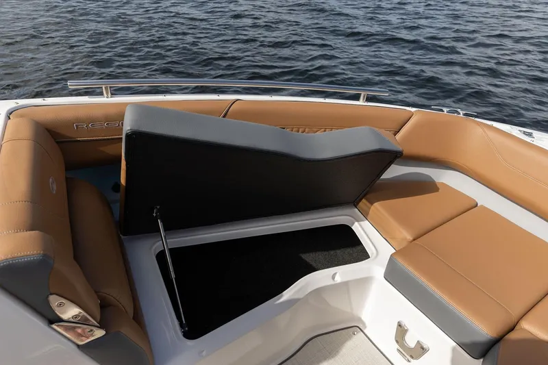 Slide: The Image of Manufacturer Provided Image: 2026 Regal LX4 boat interior with tan seating and storage compartment. - 5