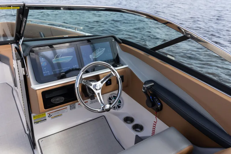 Slide: The Image of Manufacturer Provided Image: 2026 Regal LX4 boat dashboard with dual screens and steering wheel, overlooking water. - 6