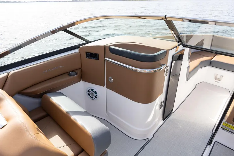 Slide: The Image of Manufacturer Provided Image: 2026 Regal LX4 boat interior with tan and gray seating, sleek design, and water view. - 7