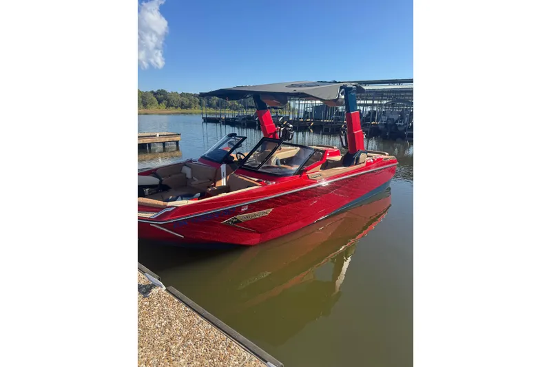 Slide: The Image of 2021 Nautique Super Air Nautique G23 Paragon in vibrant red and blue on calm water. - 1