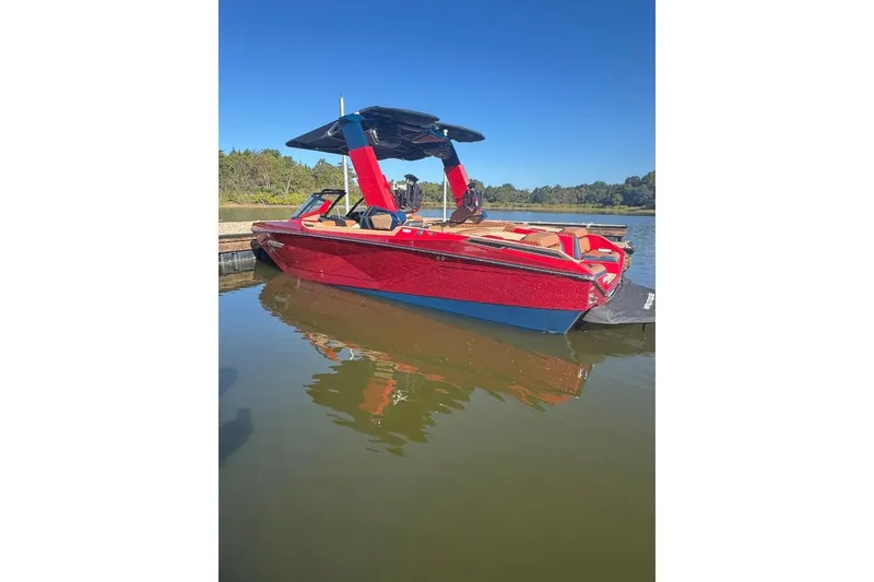 Slide: The Image of 2021 Nautique Super Air Nautique G23 Paragon in vibrant red, docked on a sunny day. - 13