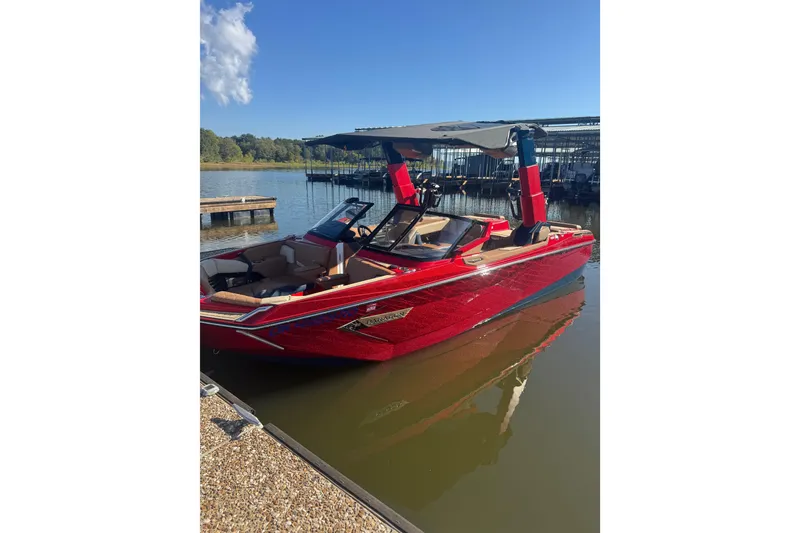 Slide: The Image of 2021 Nautique Super Air Nautique G23 Paragon in vibrant red on a calm lake. - 2