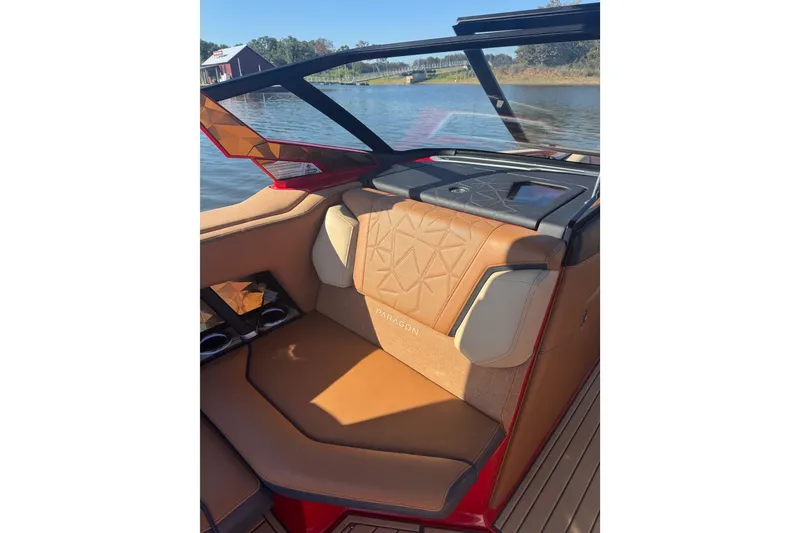 Slide: The Image of 2021 Nautique Super Air Nautique G23 Paragon interior with tan seating and wood flooring. - 6