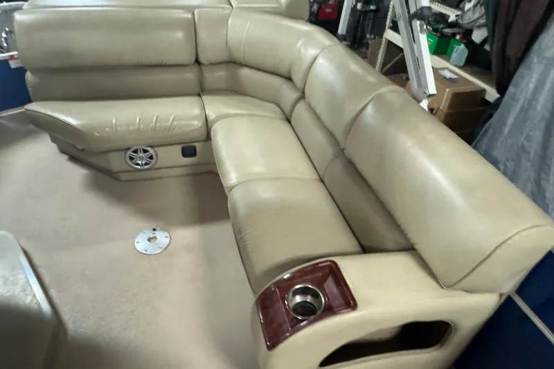 Slide: The Image of Beige leather seating on 2014 SunCatcher Elite 322 Cruise boat, featuring cup holder and speaker. - 10