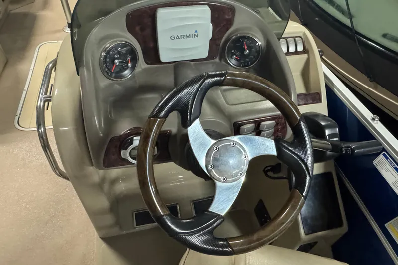 Slide: The Image of Steering console of 2014 SunCatcher Elite 322 Cruise with Garmin display and gauges. - 15