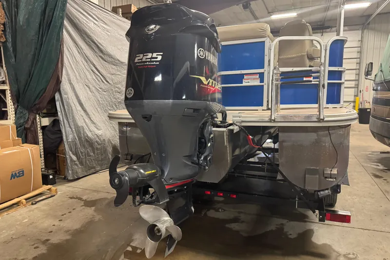 Slide: The Image of 2014 SunCatcher Elite 322 Cruise pontoon boat with Yamaha 225 engine in a garage. - 4