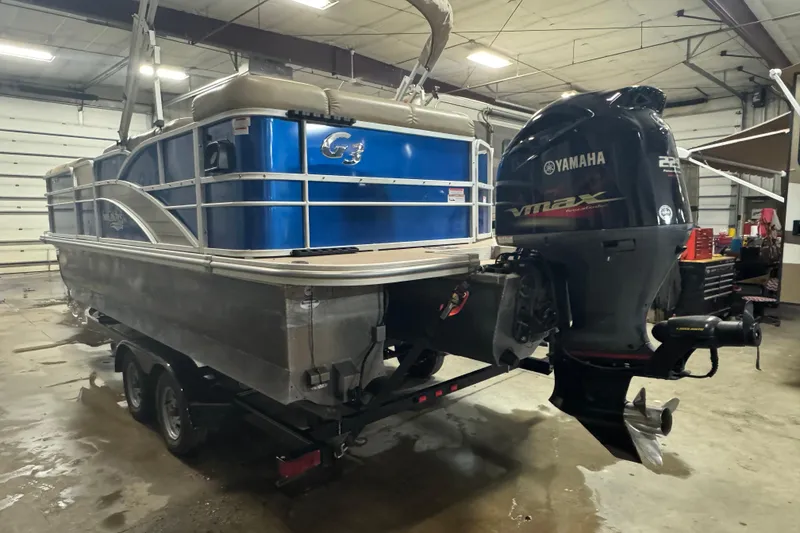 Slide: The Image of 2014 SunCatcher Elite 322 Cruise pontoon boat with Yamaha VMAX outboard motor in a garage. - 5