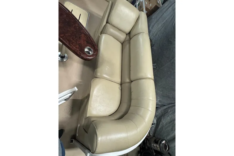 Slide: The Image of Beige leather seating on 2014 SunCatcher Elite 322 Cruise boat, with wooden table and cup holder. - 6