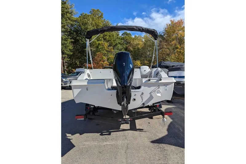 Slide: The Image of 2026 Starcraft SVX 171 OB boat, rear view with outboard motor, parked outdoors. - 3