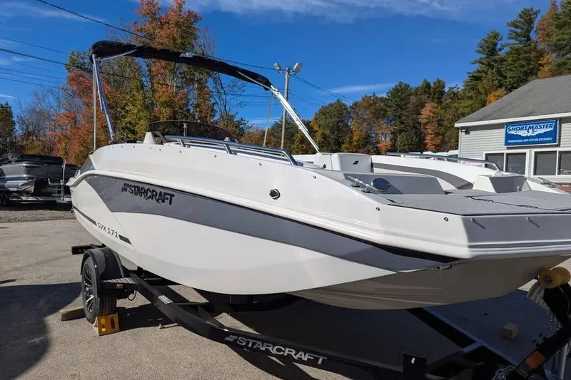 Slide: The Image of 2026 Starcraft SVX 171 OB boat on trailer, parked outdoors near dealership. - 5