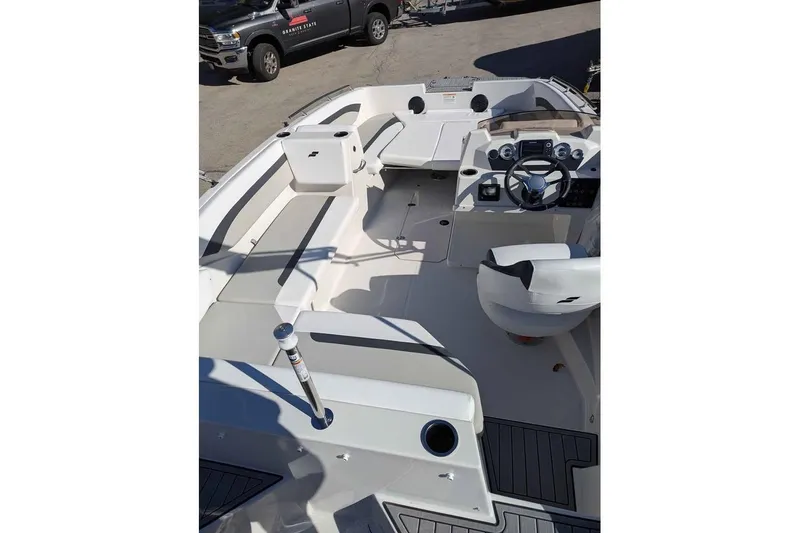 Slide: The Image of 2026 Starcraft SVX 171 OB boat interior with steering wheel and seating area. - 7