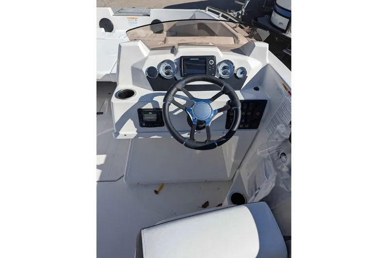 Slide: The Image of 2026 Starcraft SVX 171 OB boat dashboard with steering wheel and control panel. - 8