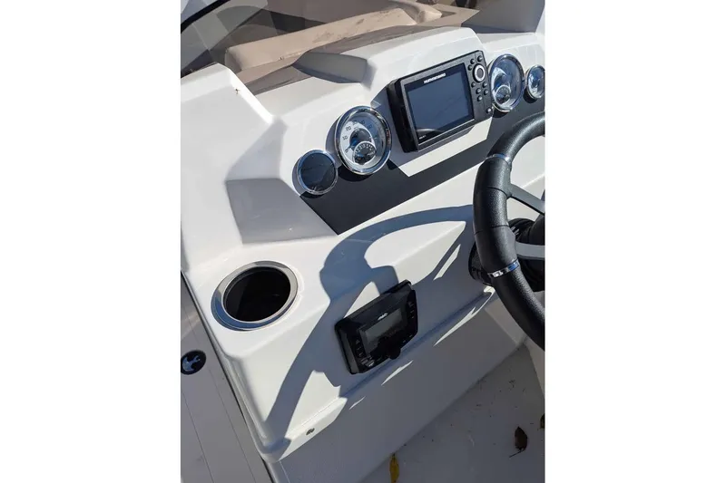 Slide: The Image of 2026 Starcraft SVX 171 OB boat dashboard with steering wheel and navigation controls. - 9