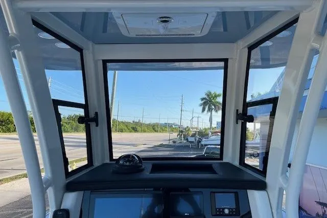 Slide: The Image of 2026 World Cat 235 TE boat interior with dashboard and windows, showcasing modern design. - 8