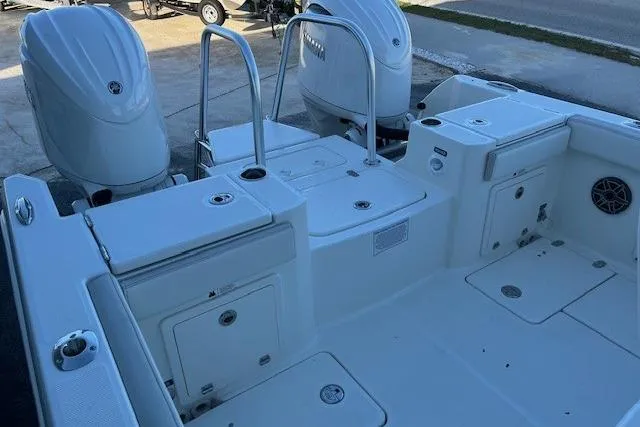 Slide: The Image of 2026 World Cat 235 TE boat deck with dual engines and storage compartments. - 9