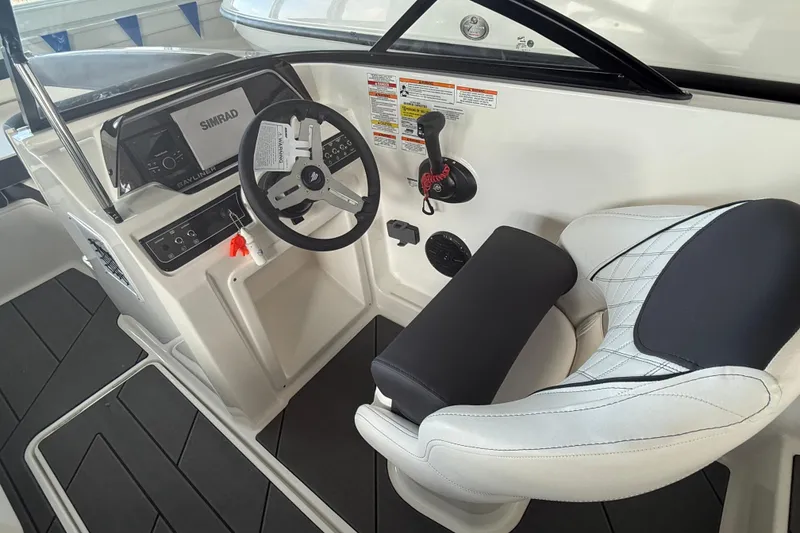 Slide: The Image of 2026 Bayliner D20 boat cockpit with steering wheel and control panel. - 13