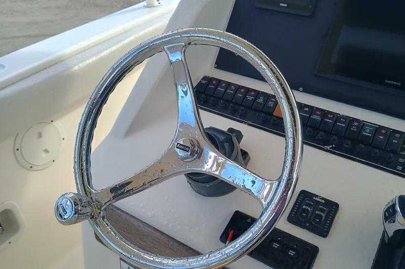 Slide: The Image of Steering wheel of 2010 Pursuit S 280 Sport boat with control panel. - 14