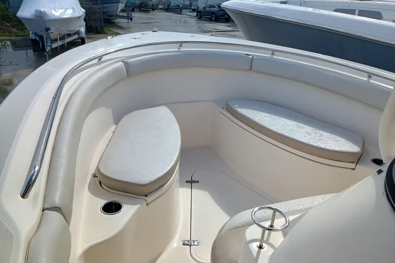 Slide: The Image of 2010 Pursuit S 280 Sport boat interior with cushioned seating and stainless steel railings. - 15
