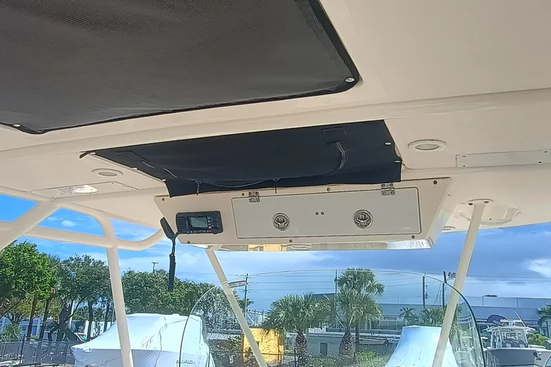 Slide: The Image of 2010 Pursuit S 280 Sport boat interior with electronic controls and overhead storage. - 17