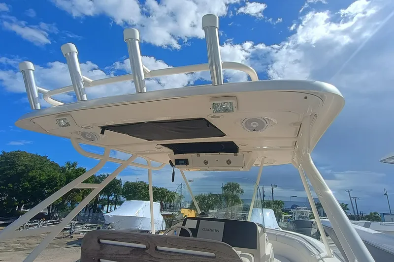 Slide: The Image of 2010 Pursuit S 280 Sport boat with T-top under a bright blue sky. - 19
