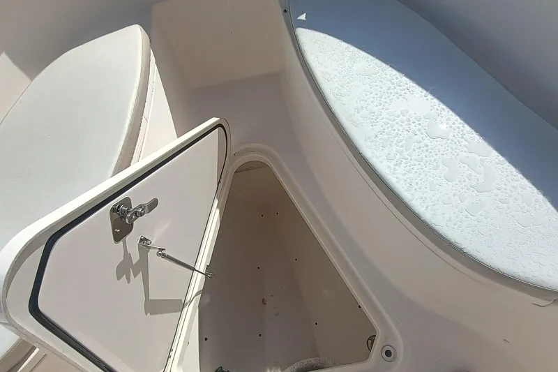 Slide: The Image of 2010 Pursuit S 280 Sport boat interior storage compartment with open hatch. - 20