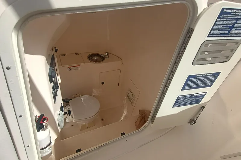 Slide: The Image of 2010 Pursuit S 280 Sport boat interior with toilet and sink. - 22