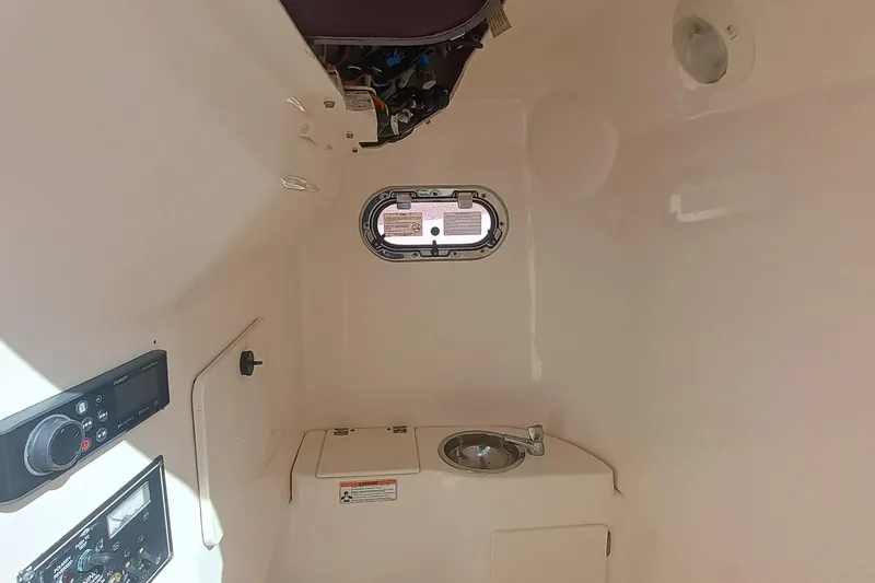 Slide: The Image of Interior cabin of 2010 Pursuit S 280 Sport boat with sink and control panel. - 23