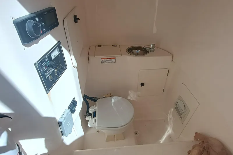Slide: The Image of 2010 Pursuit S 280 Sport boat interior with toilet and sink. - 24