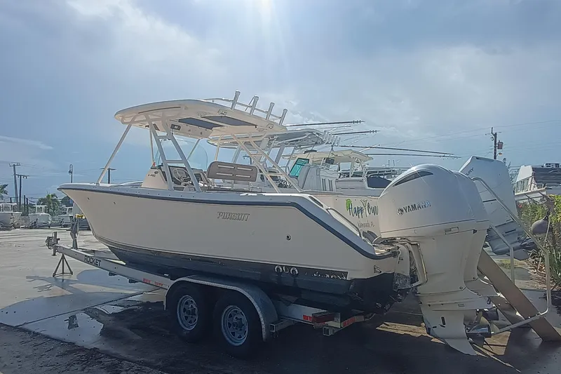 Slide: The Image of 2010 Pursuit S 280 Sport boat on trailer with Yamaha engines in a marina. - 3