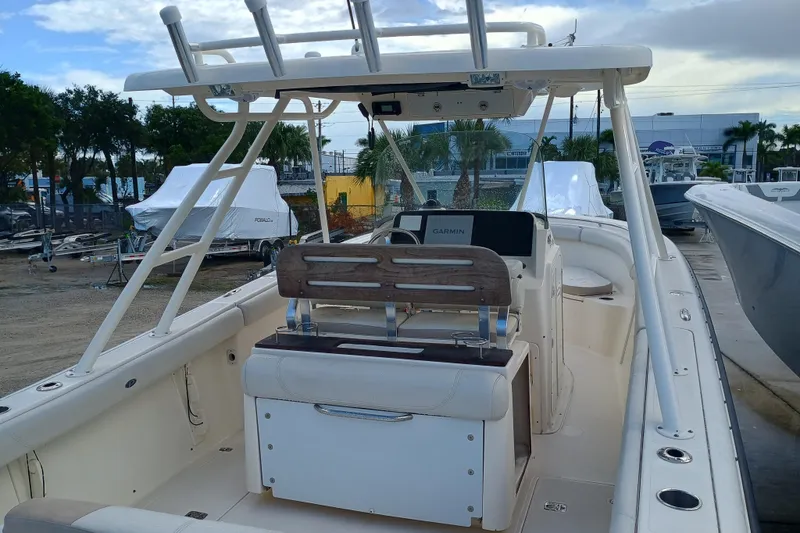 Slide: The Image of 2010 Pursuit S 280 Sport boat with Garmin navigation, docked outdoors. - 6