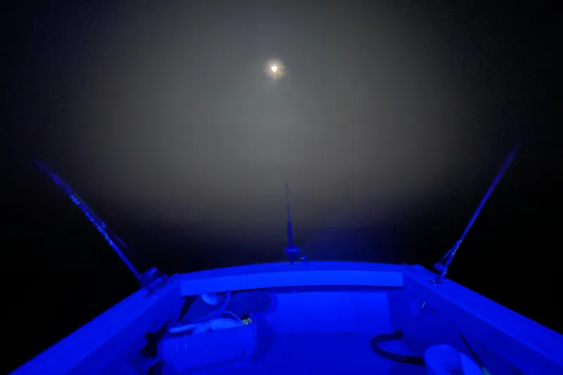 Slide: The Image of Bow of 1981 Holland 32 Sport Cruiser at sunset on calm waters. - 11