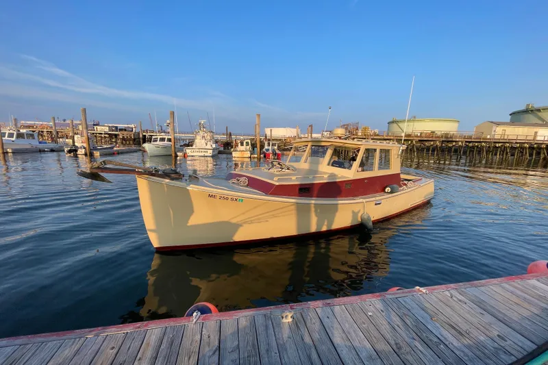 Slide: The Image of 1981 Holland 32 Sport Cruiser docked at marina, sunny day, calm water. - 2