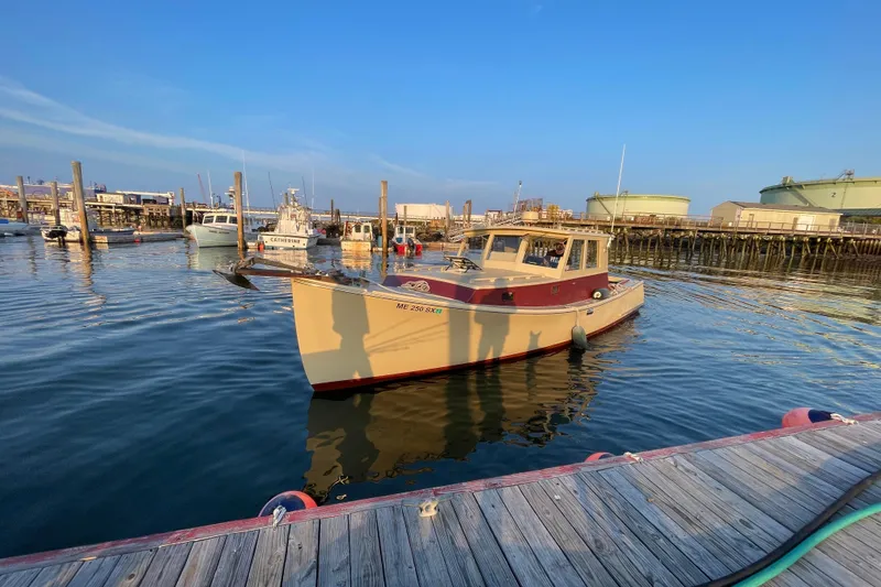 Slide: The Image of 1981 Holland 32 Sport Cruiser docked at marina, surrounded by other boats. - 3