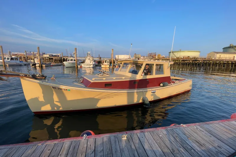 Slide: The Image of 1981 Holland 32 Sport Cruiser docked in a marina under clear blue skies. - 4