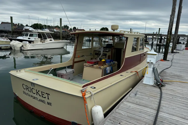 Slide: The Image of 1981 Holland 32 Sport Cruiser docked in a marina under clear blue skies. - 5