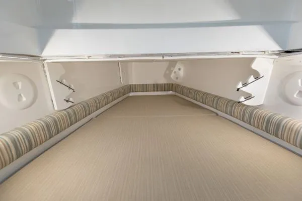 Slide: The Image of 2021 Regulator 34 boat interior with cushioned seating and storage compartments. - 15